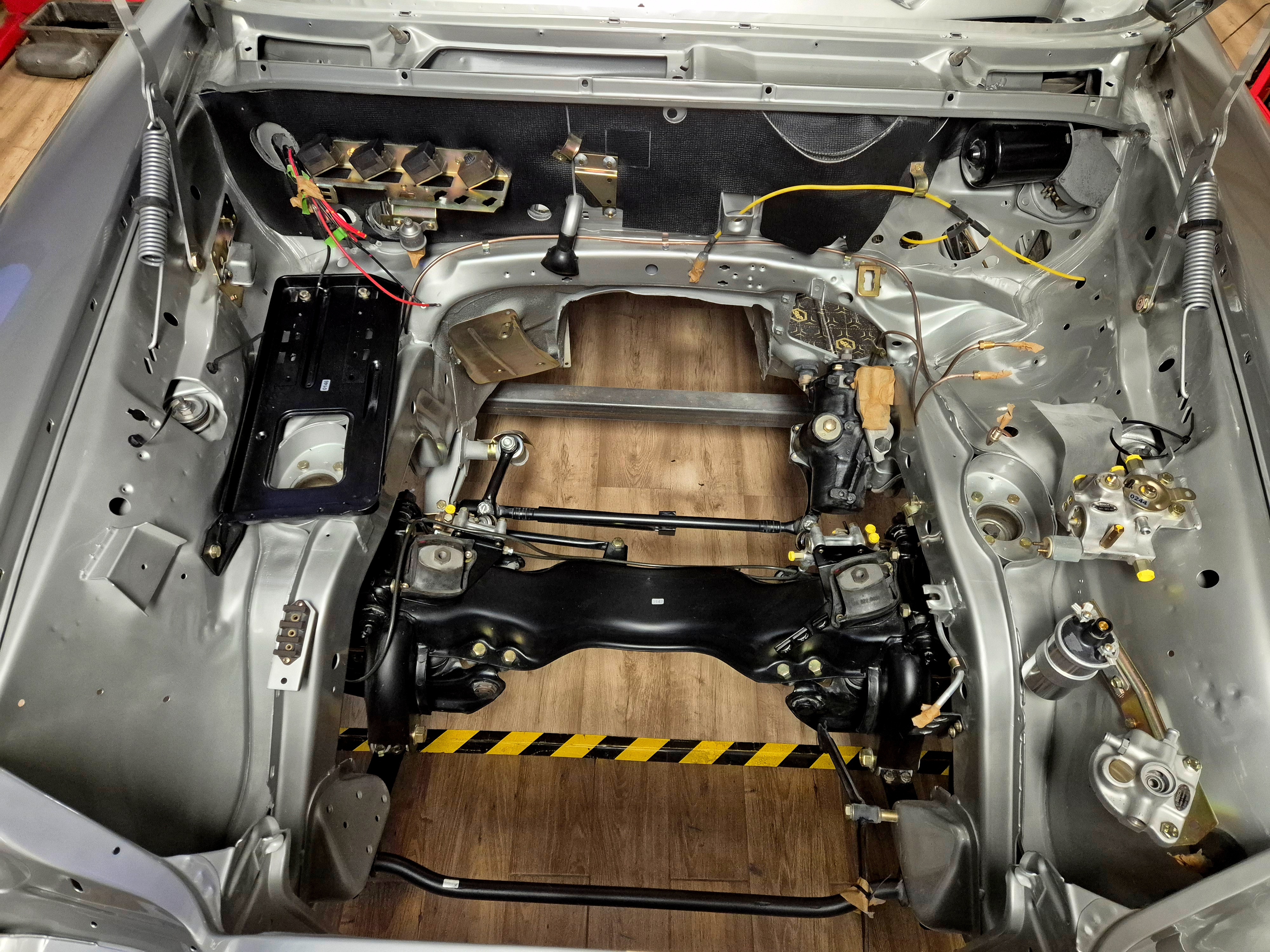Restored front suspension and engine bay of a Mercedes-Benz W109