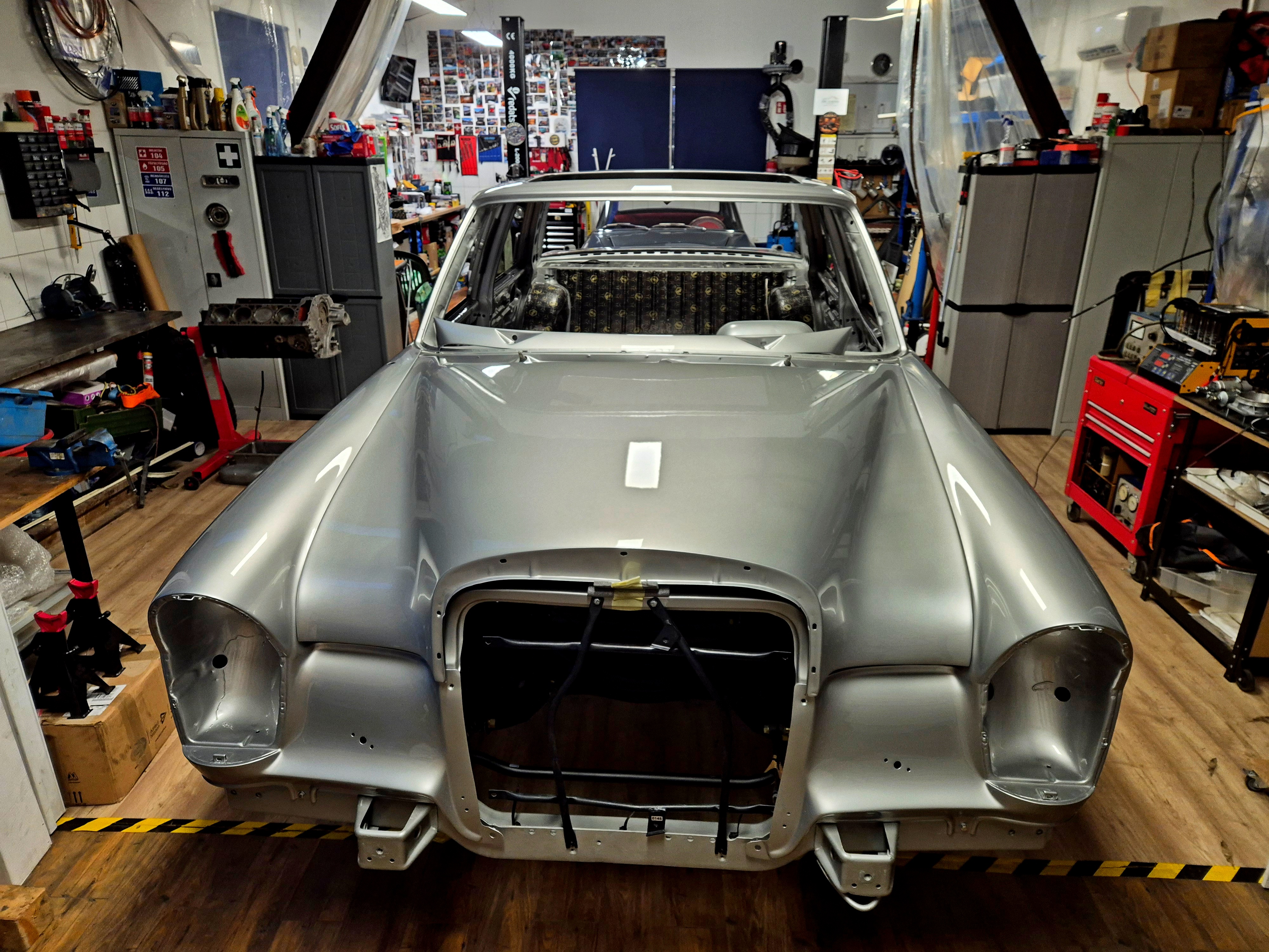 Bare Mercedes-Benz W109 body shell at the OTC Garage Hungary workshop