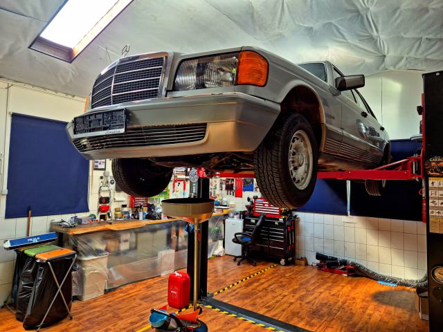 Mercedes W126 500 SEL raised for a suspension inspection